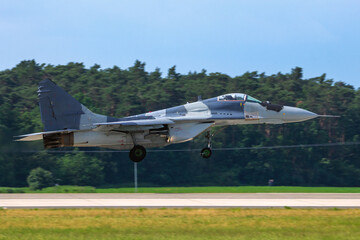 Russian made fighter jet landing on an airbase