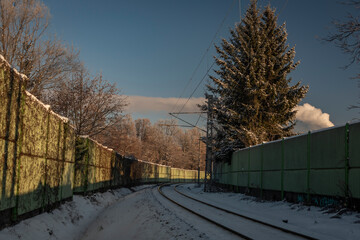 Snowy frosty railway near Ceske Budejovice city with big tree