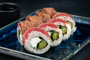 Set of Japanese sushi rolls with seared tuna, cream cheese, zucchini and soy sauce. © smspsy