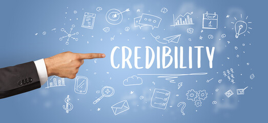 Close-Up of cropped hand pointing at business inscription