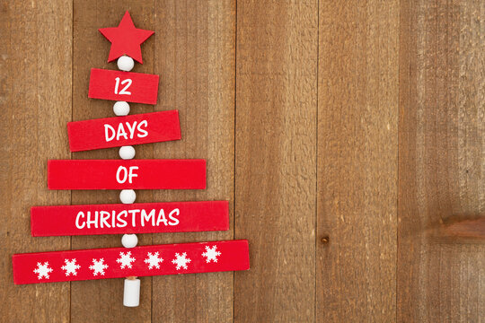 12 days of Christmas message on a Christmas tree on weathered wood