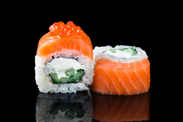 Sushi rolls Philadelphia with salmon, cream cheese, cucumber and red caviar.