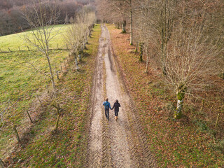 Obraz na płótnie Canvas Couple walking hand in hand along the Camino de los Canonigos. Roncesvalles