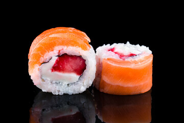Japanese cuisine sushi rolls with tuna, salmon, cream cheese, rice and nori.
