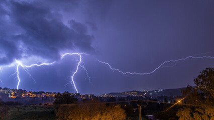 Two big and glorious lightnings that fell across the city at night.