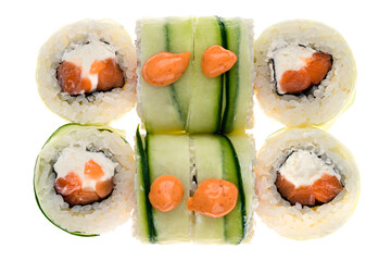 Sushi rolls with salmon, cream cheese, rice and nori in slices cucumber isolated on white.