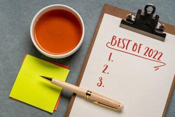 best of 2022 - blank list on a clipboard, flat lay with a cup of tea, product or business review of the recent year