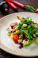 Meat salad with veal, sun-dried tomatoes, cherry tomatoes, grissini sticks, green salad and herbs.