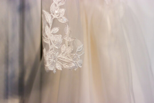 A floor design stitched into a white wedding dress.