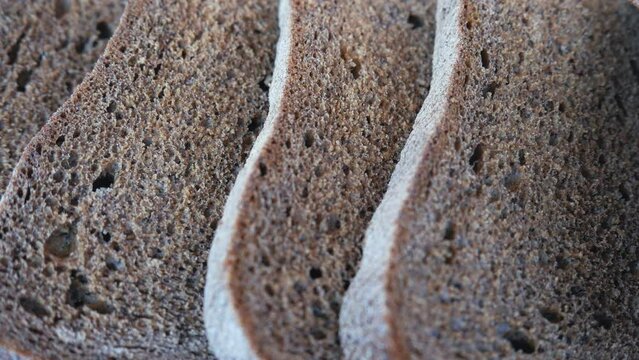 There are many pieces of stale bread in the breadbasket. Food losses and food waste. Spoiled extra bread