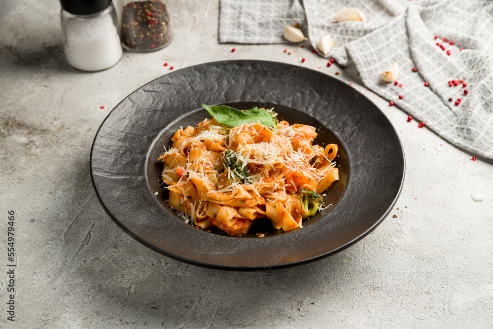 Sticker Fettuccine with shrimps with tomato sauce and parmesan on grey table