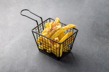 french fries on grey table, side view