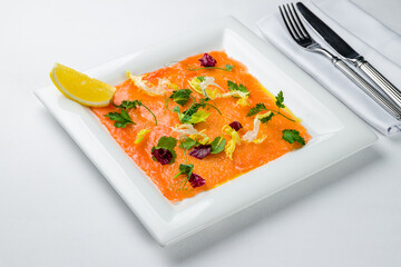 Salmon carpaccio on a plate on white plate
