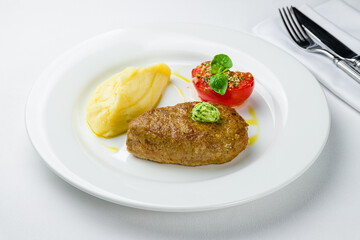 Homemade beef cutlets with potatoes on white plate