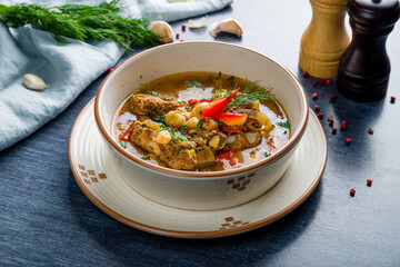 Leg of lamb baked with vegetables and nut on bowl