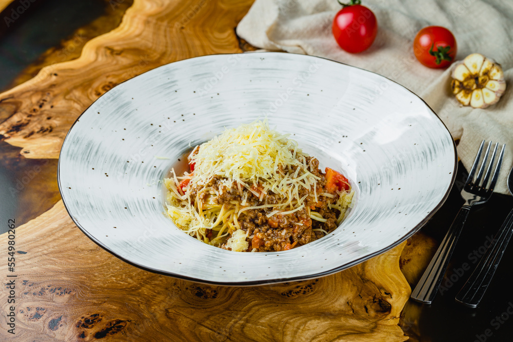 Wall mural pasta spaghetti bolognese with parmesan on wooden table