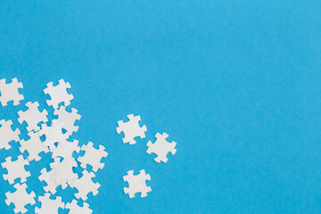 White puzzles on a blue background, flat lay. - Powered by Adobe
