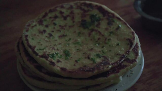 stack of cooked garlic butter naan bread