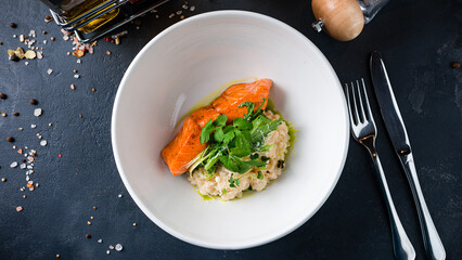 Salmon fillet with creamy ptitim, parmesan cheese, parsley and lettuce.