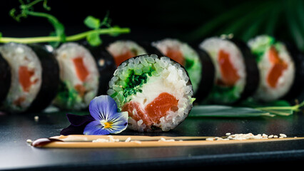 Sushi rolls with salmon, cream cheese, marinated seaweed chuka, ice and nori.