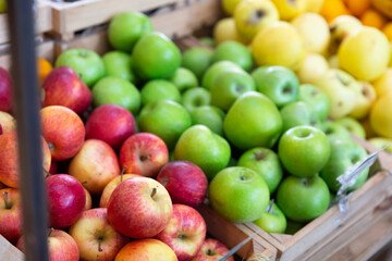 Naklejka na ściany i meble Many of fresh ripe apples on the market, puts out for sale. Close-up image