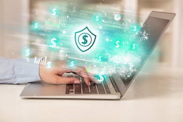 Young man watching stock market on laptop