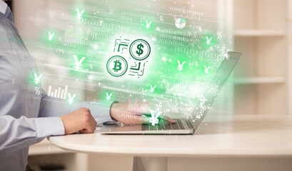 Young man watching stock market on laptop