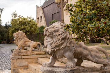 Large stone figures of lions on the stairs in the Spanish city