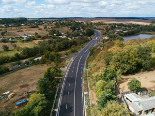 Aerial view asphalt road and green forest, Forest road going through forest with car adventure view from above, Ecosystem and ecology healthy environment concepts and background.