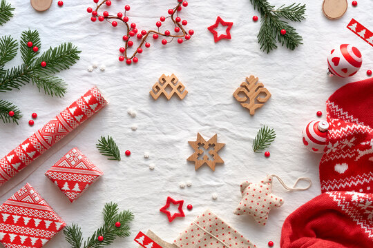 Blessed Yule, Christmas, Latvian winter festival. Ethnographic symbols and patterns from Latvia, wood amulets, wrapping paper, gift boxes with fir twigs and berries. Baltic seasonal patterns in red.