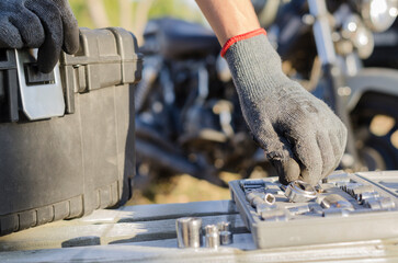 motorcycle mechanic prepares to perform a service on a motorcycle