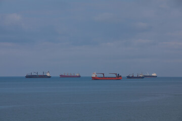 Seascape with cargo vessel and container ship on the horizon