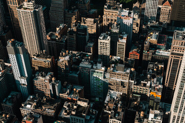 A bird's eye view of New York City's skyscrapers and apartment buildings. Aerials view of Manhattan from the Empire State Building