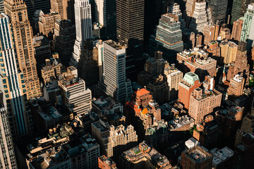 A bird's eye view of New York City's skyscrapers and apartment buildings. Aerials view of Manhattan from the Empire State Building