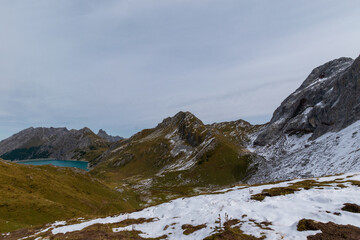 L&uuml;nersee in the Austrian Alps with snowy slopes