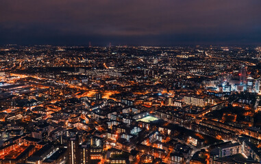 Aerial view of south London, blue hour just after sunset, orange yellow street lights starting to glow