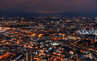 Aerial view of south London, blue hour just after sunset, orange yellow street lights starting to...