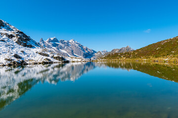 Naklejka na ściany i meble The clear tarn reflects the surrounding alpine panorama (Tobelsee, Vorarlberg, Austria)