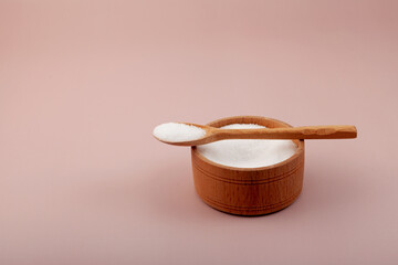 Sugar substitute. Stevioside powder or Stevia sweetener in wooden bowl. Food additive E960. Natural Extract found in the leaves of Stevia rebaudiana