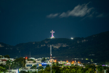 Large monument Cristo de Chiapas high in the mountains at night.
