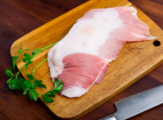 Raw slice of Iberian pork secret, small piece cut between shoulder and bacon of pig on wooden...