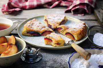 Homemade plum pie and cup of tea. New York Times recipe plum cake