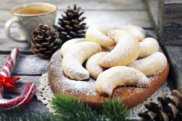 Vanillekipfer cookies. Amanda crescents Christmas cookies, powdered sugar dressing, cup of coffee,  new year decoration - 554997425