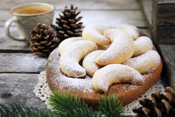 Vanillekipfer cookies. Almond crescents Christmas cookies, powdered sugar dressing, cup of coffee,  new year decoration - 554997428