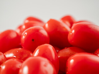 Red cherry tomatoes. Red tomatoes on a white background.
