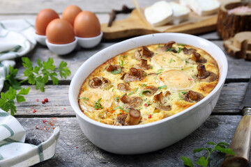 Vegetable mushroom clafoutis ( flan ) with leeks and goat cheese in ceramic bakeware