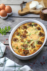 Vegetable mushroom clafoutis ( flan ) with leeks and goat cheese in ceramic bakeware