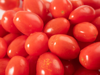Red cherry tomatoes. Red tomatoes on a white background.