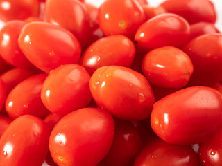 Red cherry tomatoes. Red tomatoes on a white background.