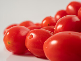 Red cherry tomatoes. Red tomatoes on a white background.